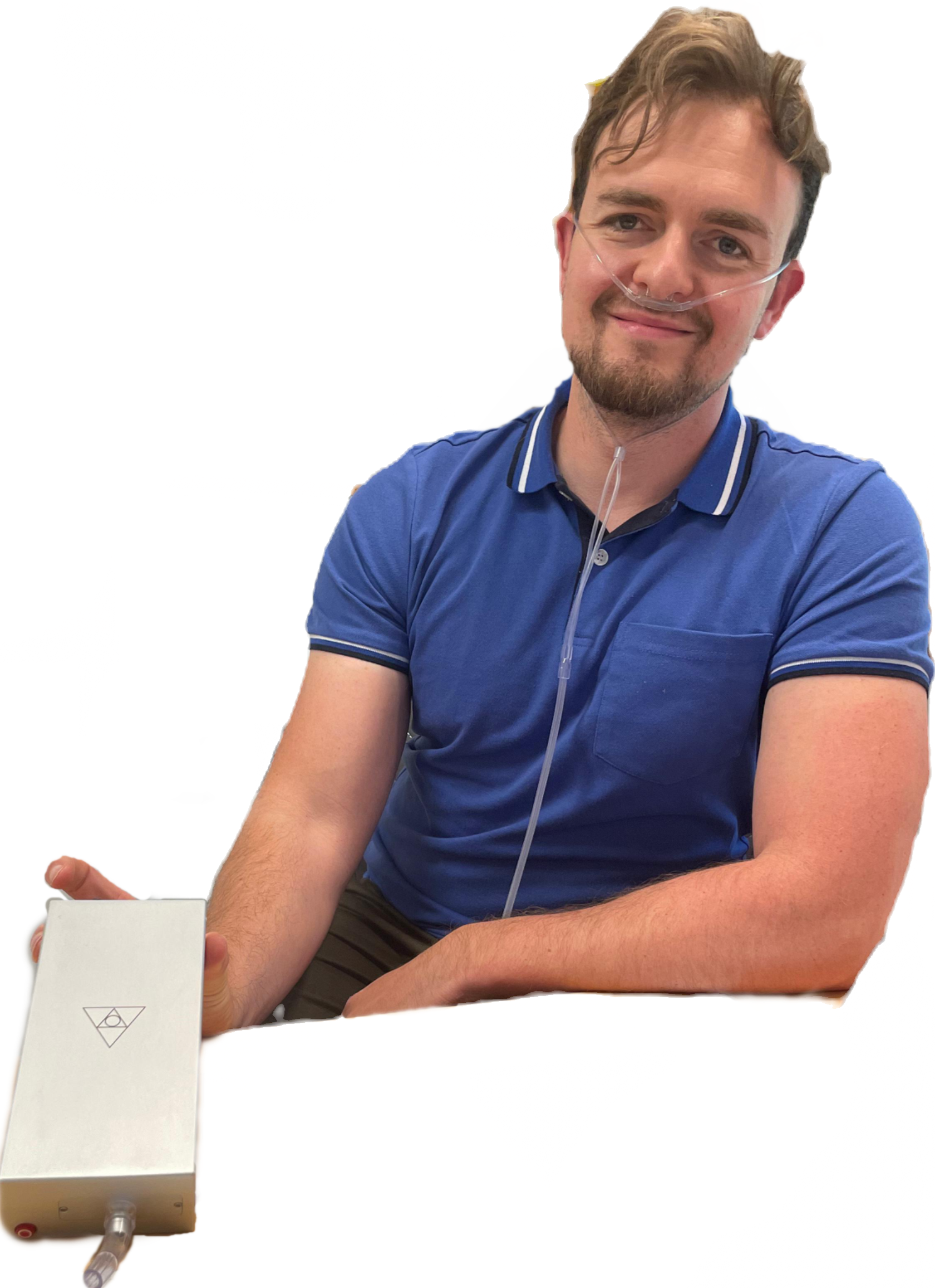 Man in a blue polo shirt with a nasal cannula holding the Forest Air Home.